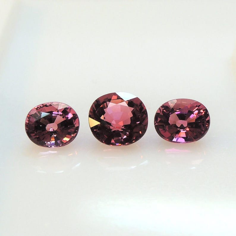 Raspberry pink tourmaline, this trio of oval and purplish-pink cushion-cut gems weighs 3.56 carats and comes from Africa image 8