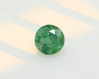 Natural untreated emerald 5.9 mm round, this medium green beryl weighs 0.89 carat and comes from the Republic of Zambia