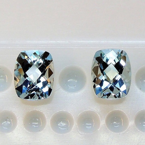 Aigue-marine bleu glacier, cette paire de béryl bleu ciel coussin allongé mesure 7.1x9.0 mm coupe échiquier et pèse 3.74 carats