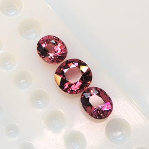 Raspberry pink tourmaline, this trio of oval and purplish-pink cushion-cut gems weighs 3.56 carats and comes from Africa image 6