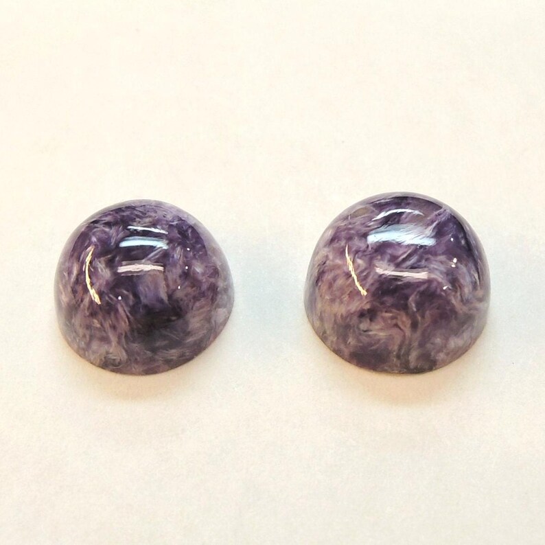 Charoite pair, round 11mm cabochons, these marbled purple cabochons come from Siberia in Russia and weigh 10.67 carats. image 7