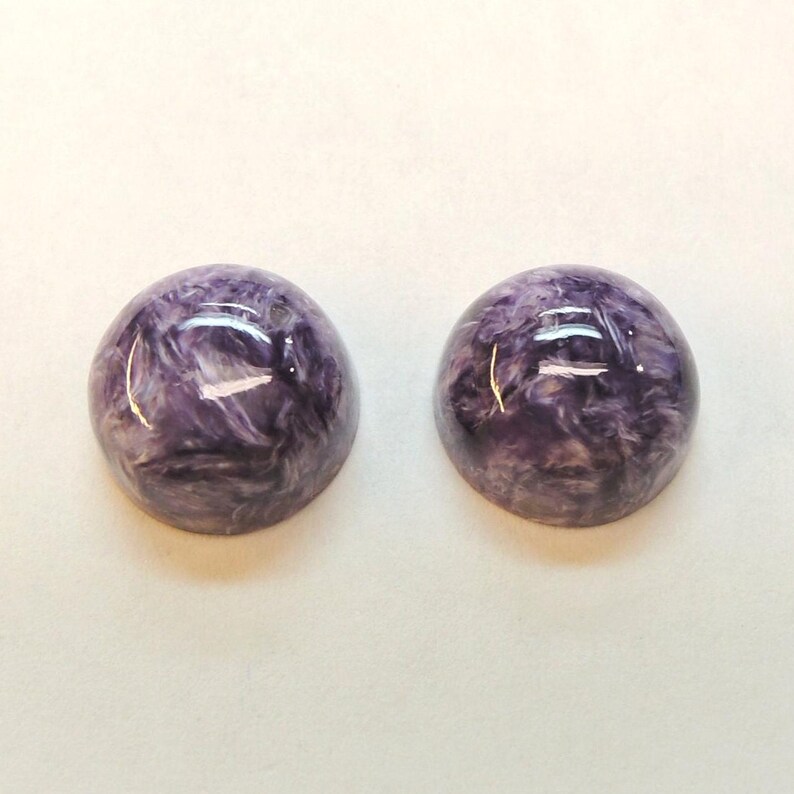 Charoite pair, round 11mm cabochons, these marbled purple cabochons come from Siberia in Russia and weigh 10.67 carats. image 3