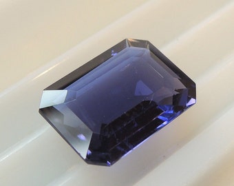 Iolite emerald cut, purplish blue cordierite, this large gem weighs 7.74 carats, this large stone measures 11.5x15.5 mm