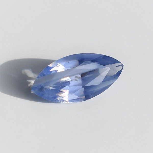 Pastel blue sapphire slightly lavender marquise 10x5 mm, this transparent corundum with milky band weighs 1.46 carat and comes from Ceylon