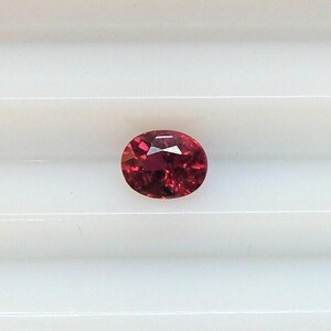 Small, very red oval ruby, 3.7x4.7 mm, this transparent gem weighs 0.40 carats and comes from Africa