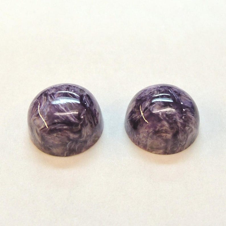 Charoite pair, round 11mm cabochons, these marbled purple cabochons come from Siberia in Russia and weigh 10.67 carats. image 4