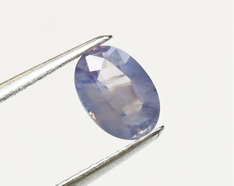 Oval cloudy lavender sapphire 7.8x5.5 mm, this transparent to translucent milky faceted stone weighs 1.26 carat and comes from Sri Lanka