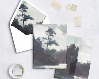 May include: Stationery set featuring a watercolor landscape with a tall tree and a body of water. The set includes cards, an envelope, and stamps. The artwork is in shades of gray, blue, and white.