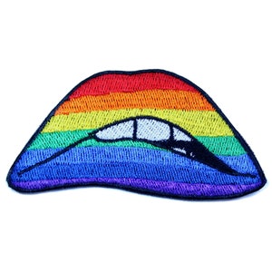 May include: Rainbow-colored embroidered patch shaped like a pair of lips with a white tooth design.
