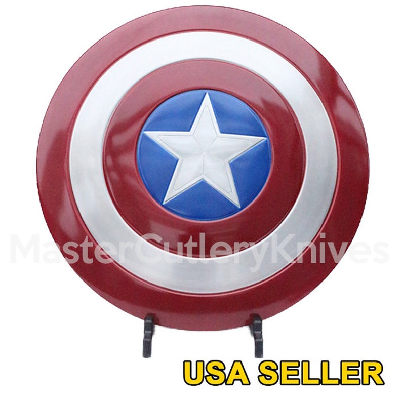 May include: A red, white and blue Captain America shield with a silver metal rim and a five-pointed white star on a blue background. The shield is on a black stand. USA SELLER.