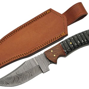 May include: A Damascus steel hunting knife with a brown wood handle and a black and gray patterned grip. The knife comes with a brown leather sheath.