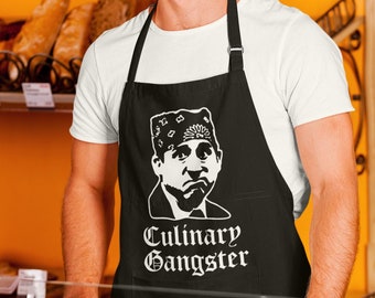 May include: A black apron with a white image of a man wearing a bandana and the text "Culinary Gangster".