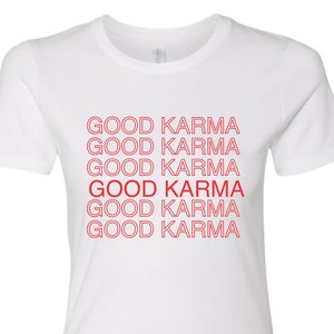 May include: White t-shirt with the phrase "GOOD KARMA" repeated six times in red.