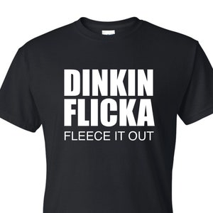 May include: Black t-shirt with white text that reads "Dinkin Flicka Fleece It Out"