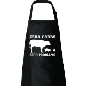 May include: Black kitchen apron with a white silhouette of a cow, pig, and chicken with the text "Zero Carbs Zero Problems".