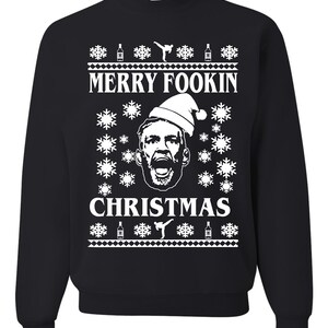 May include: Black crew neck sweatshirt with a white graphic design. The design includes the text "MERRY FOOKIN CHRISTMAS" with a face wearing a Santa hat, snowflakes, beer bottles, and a karate kick figure.
