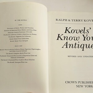 May include: Open book titled "Kovels' Know Your Antiques" by Ralph & Terry Kovel. The book is revised and updated, published by Crown Publishers, Inc. in New York. A second book is partially visible.