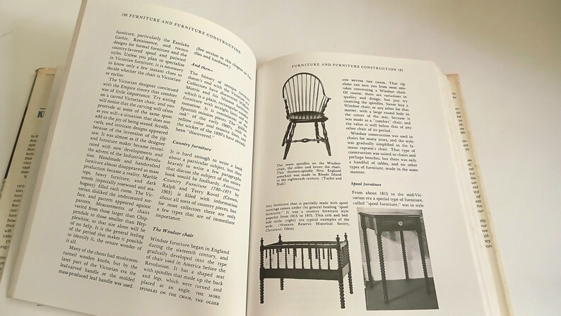 May include: Open book with text and illustrations about furniture construction. The pages show drawings of chairs and other furniture pieces. The text includes information about different furniture styles and their history.