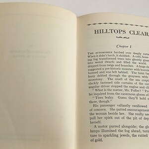 May include: Open vintage book with the title "HILLTOPS CLEAR" and "Chapter 1" visible. The pages are aged with text in black ink. The book is open, displaying the text on the right page.