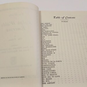 May include: Open book with a red spine, displaying the "Table of Contents" for a collection of poems. The page features a list of poems with corresponding page numbers, printed in black ink on off-white paper.