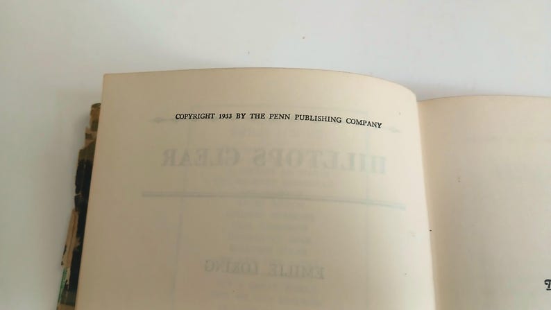 May include: Open book pages with text. The top page reads "COPYRIGHT 1933 BY THE PENN PUBLISHING COMPANY" in black font. The title "HILLTOP'S CLEAR" is visible in reverse on the page. The book's pages are off-white.
