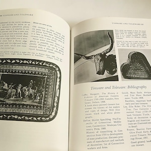 May include: An open book featuring pages on tinware and toleware. One page displays a black and white image of a decorative tray with a detailed scene. The opposite page includes images and a bibliography.
