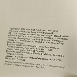 May include: A page from a book with text about antiques and interior room settings. The text includes copyright information, publisher details, and the Library of Congress catalog card number. The book was published in the United States.