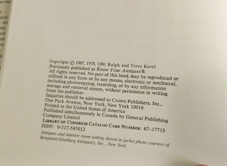 May include: A page from a book with text about antiques and interior room settings. The text includes copyright information, publisher details, and the Library of Congress catalog card number. The book was published in the United States.