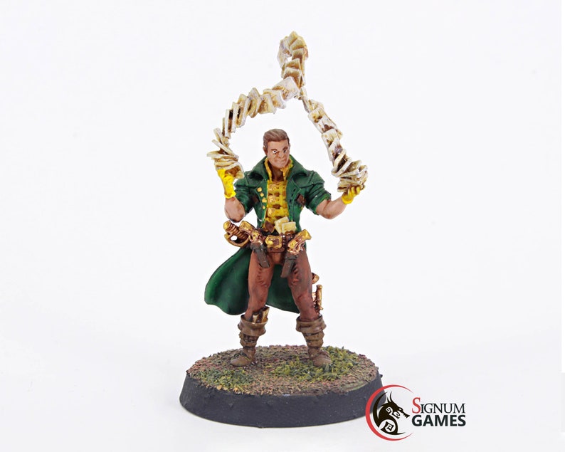 May include: A painted miniature figurine of a man wearing a green coat and brown pants, holding a swirling stack of cards in his right hand. The figurine is standing on a black base with green grass.