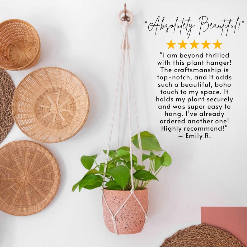 May include: A macrame plant hanger with a pink speckled pot and a green plant hanging from it. The hanger is made of natural cotton rope and has a simple, bohemian style. The background features a white wall with wicker baskets and mats.