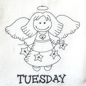 Pode incluir: Tecido branco com um desenho de anjo bordado em preto. O anjo tem um halo, asas e segura ornamentos em forma de estrela. A palavra "TUESDAY" est&aacute; bordada abaixo.