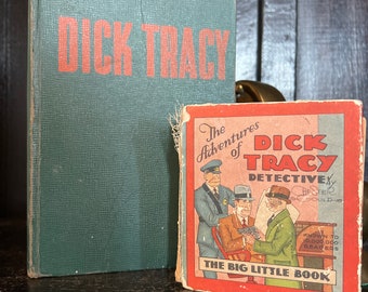 May include: Two vintage paperback books with green and red covers. The larger book is titled "Dick Tracy" in red letters. The smaller book is titled "The Adventures of Dick Tracy, Detective" with a drawing of three men in suits. The text on the smaller book also says "Known to 10,000,000 Readers" and "The Big Little Book."