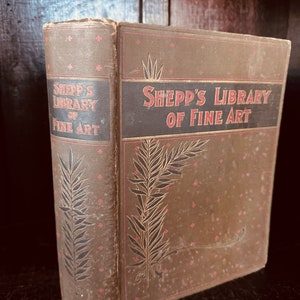 Könnte beinhalten: Ein Vintage-Buch mit dem Titel "Shepp's Library of Fine Art" mit braunem Einband und goldenen Lettern. Der Einband zeigt ein dekoratives Design aus Blättern und Sternen.