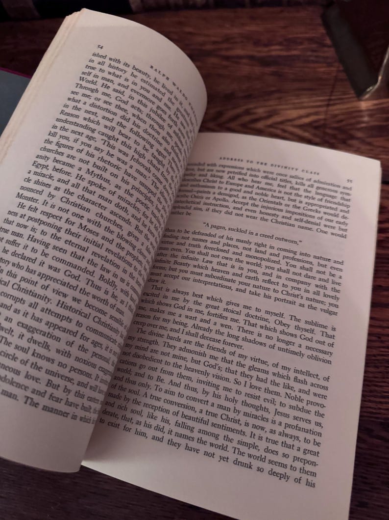 May include: Open book with text on aged paper, angled to show both pages. The text is in English, with visible page numbers and a vintage aesthetic. The book's pages are yellowed, suggesting age and use.