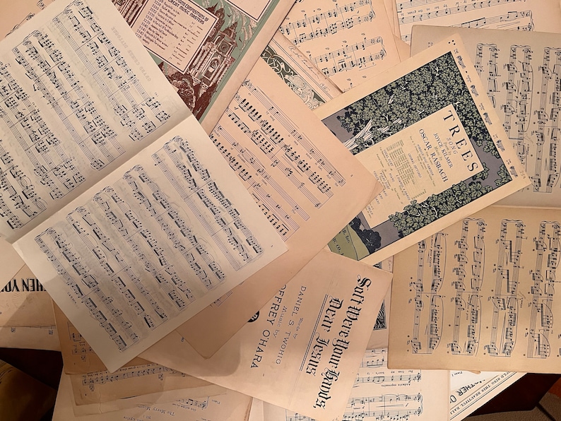 May include: A collection of vintage sheet music featuring musical scores and song titles like "Trees" and "Soft Were Your Hands, Dear Jesus".