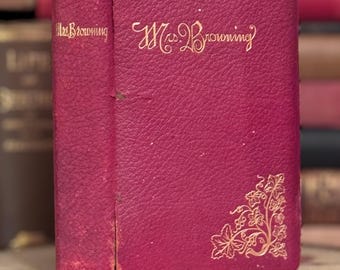 May include: A vintage, red leather-bound book with gold lettering that reads "Mrs. Browning" on the cover. The book has a decorative floral design on the bottom right corner.