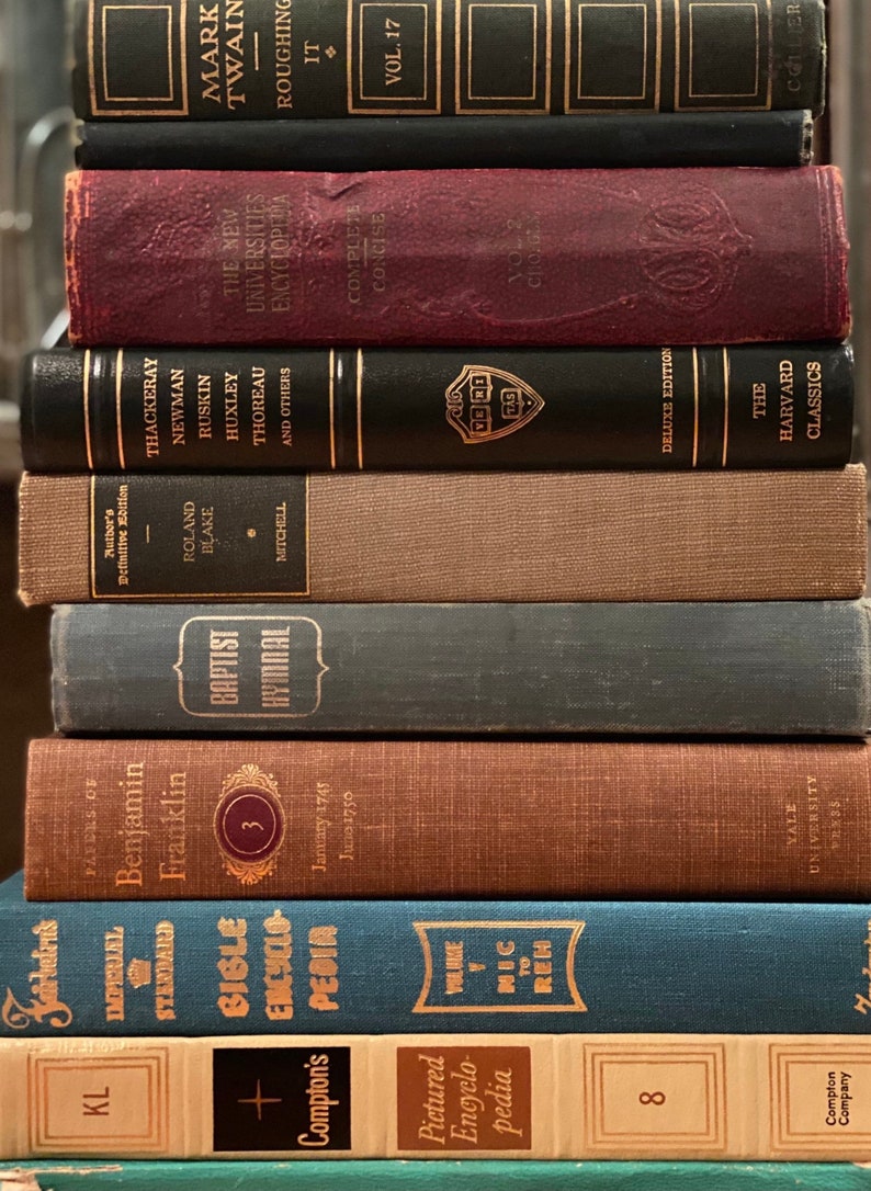 May include: A stack of vintage hardcover books with various titles and authors. The books are arranged in a vertical stack, with the top book being a black hardcover with gold lettering. The bottom book is a green hardcover with gold lettering. The books are all in good condition and appear to be well-loved.