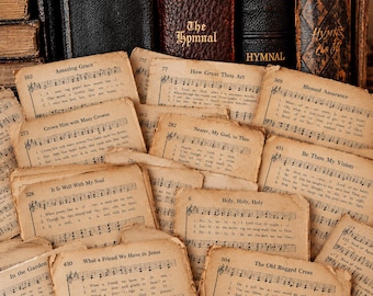 May include: A collection of vintage, aged paper hymn sheets featuring musical notation and lyrics for songs like Amazing Grace, How Great Thou Art, and The Old Rugged Cross, arranged in front of several antique, dark-bound hardcover books.