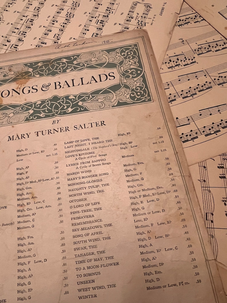 May include: A vintage sheet music book with a green and gold decorative border. The title is "Songs & Ballads" by Mary Turner Salter. The book lists a variety of songs with their key signatures and tempos.