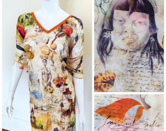 May include: A beige silk dress with a V-neck and short sleeves. The dress features a colorful print of various images, including a woman's face, birds, flowers, and handwritten text. The dress has a brown trim around the neckline. The text on the dress reads "Jane Paul Gautier Soleil".