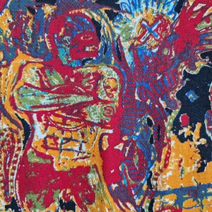 May include: A black fabric with a colorful abstract pattern. The pattern features red, yellow, blue, and green colors. The fabric has a textured surface.