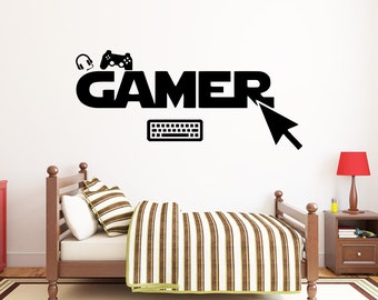 May include: Black and white wall decal with the word "GAMER" in bold letters. The decal also includes a video game controller, headphones, a keyboard, and a computer mouse cursor.