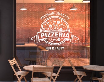 May include: A storefront window with a white sign that says "Premium Quality Pizzeria Hot & Tasty" with a graphic of a pizza. The sign is on a brick wall. There are four wooden chairs and two tables outside the storefront.