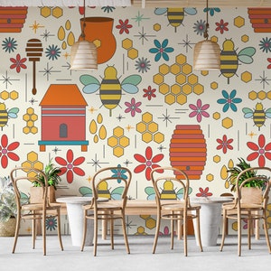 May include: A dining room with a light beige wall featuring a repeating pattern of honeycombs, bees, flowers, and honey jars. The wall is decorated with a whimsical bee-themed design. Four wooden chairs surround a wooden table with a white stone top.