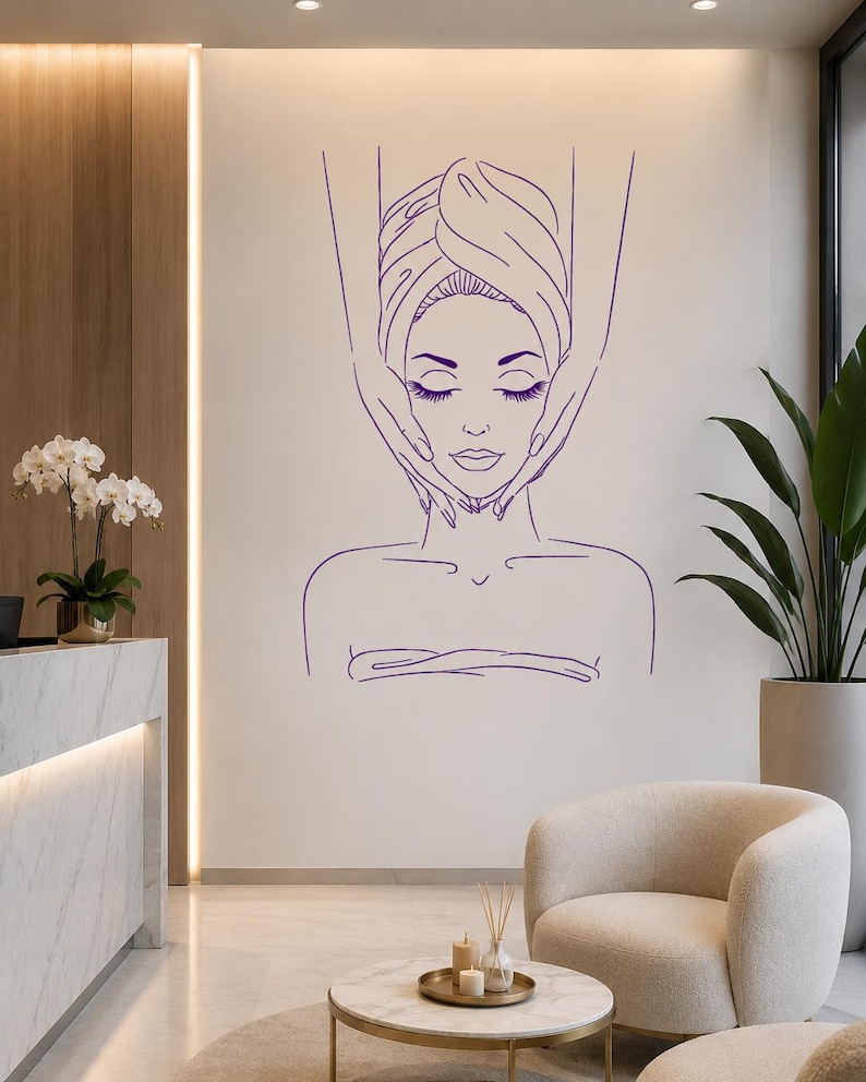 May include: A purple line art wall decal featuring a person with eyes closed, wrapped in a towel, receiving a facial massage from two hands. The minimalist graphic design depicts a serene spa treatment scene with clean, continuous outlines.