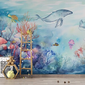May include: A watercolor mural depicting an underwater scene with a whale, coral, fish, a turtle, an octopus, and a jellyfish. The mural is painted in shades of blue, pink, and green.