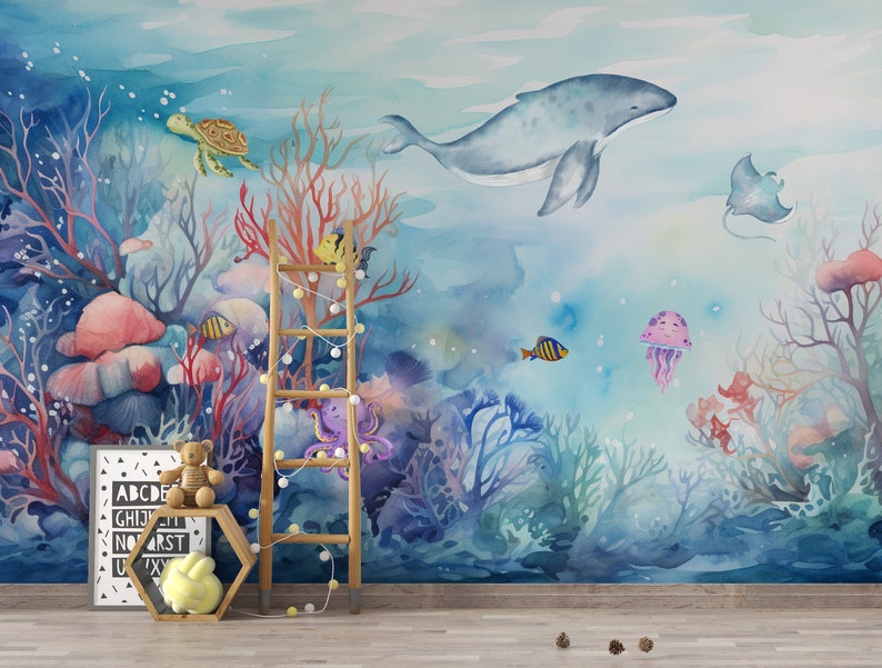 May include: A watercolor mural depicting an underwater scene with a whale, coral, fish, a turtle, an octopus, and a jellyfish. The mural is painted in shades of blue, pink, and green.