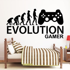 May include: Black and white wall decal featuring a silhouette of the evolution of man, ending with a man holding a video game controller. The text "EVOLUTION GAMER" is below the image.