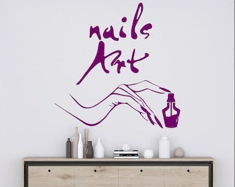 May include: Purple vinyl decal with the words "nails art" and a stylized image of a hand holding a bottle of nail polish.