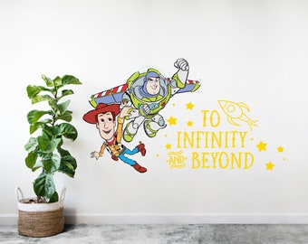 May include: A wall decal featuring Woody and Buzz Lightyear from Toy Story. Woody is holding onto Buzz's spaceship as they fly through space. The decal also includes the text "To Infinity and Beyond" and stars.